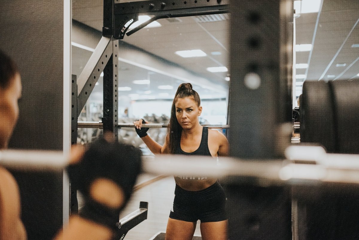 woman in black sports bra and black shorts doing exercise